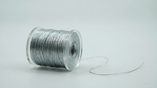 Silver Thread on Spool with Background for Creative Projects