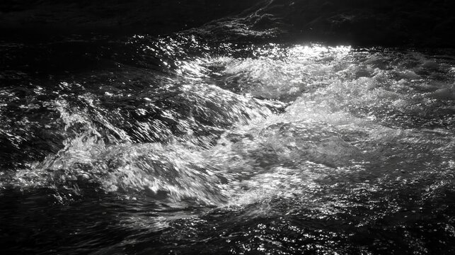 Black and white motion shot of churning river water ripples