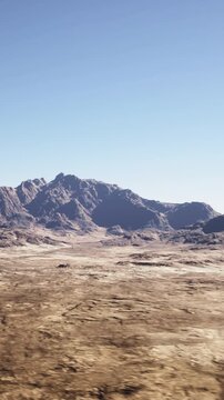 dramatic cinematic desert landscape under clear sky, natural backlot for virtual production and commercial shoots, strong light and texture for VFX plates
