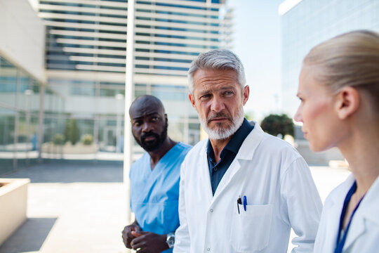 Medical team discussing patient case outside hospital