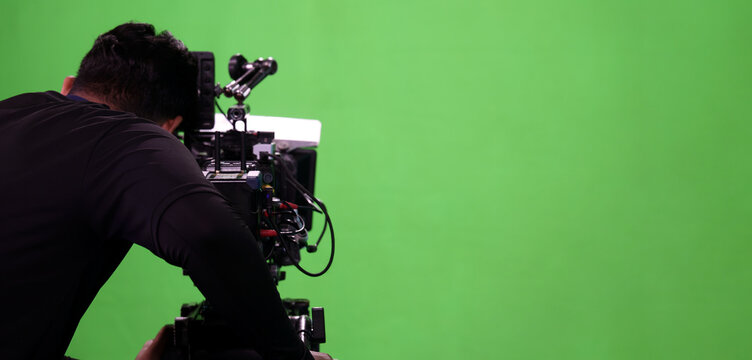 Behind the scenes. BTS of TV commercial movie film or video shooting production which pro camera crew setting up on green screen for chroma key technique in studio. Greenscreen background shooting set
