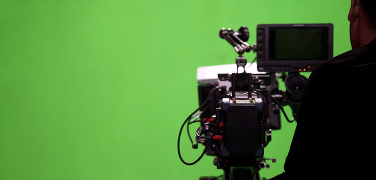 Behind the scenes. BTS of TV commercial movie film or video shooting production which pro camera crew setting up on green screen for chroma key technique in studio. Greenscreen background shooting set