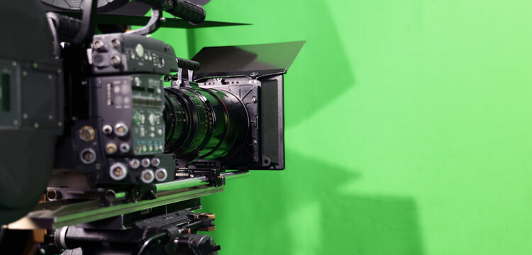 Behind the scenes. BTS of TV commercial movie film or video shooting production which pro camera crew setting up on green screen for chroma key technique in studio. Greenscreen background shooting set