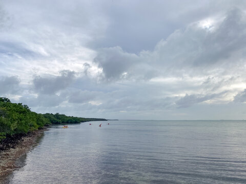 Cloudy skies over Elliott Key with kayakers in the distance 