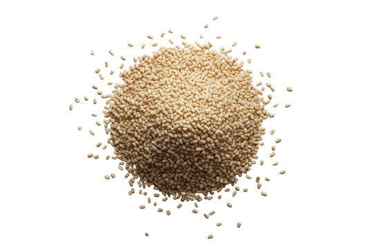 Pile of small beige dry granules with scattered particles