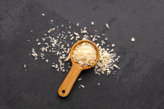 Panko, or Japanese-style breadcrumbs, in a measuring spoon on a black slate background.