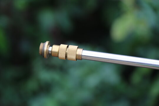 Brass fitting on the agriculture sprayer machine extension rod on a nature background