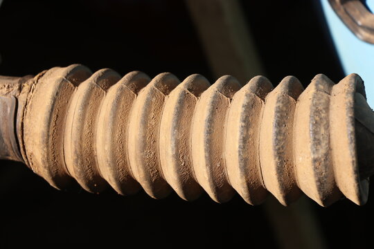 Close up of an old dusty rubber steering rack boot showing its ribbed bellows design