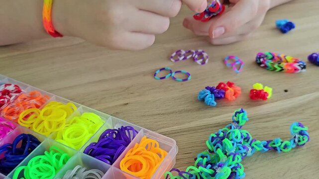 Creating colorful rubber band bracelets in a craft session at home