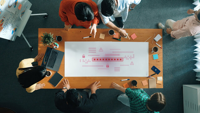 A diverse team engages in a collaborative project planning session, utilizing charts and digital devices on a modern office table, fostering creativity and innovation. Trope