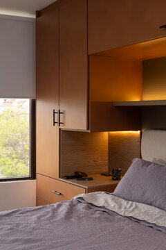 Elegant bedroom interior with cozy bed and warm indirect lighting for modern home design