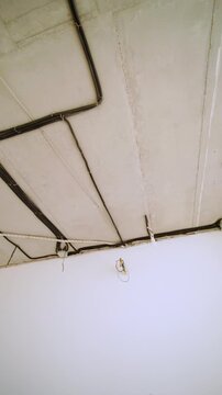 Exposed electrical conduits on unfinished concrete ceiling