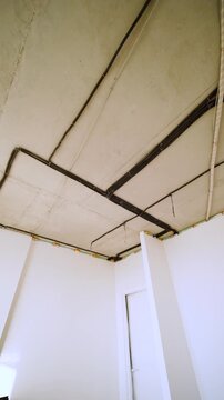 Electrical conduits installed across unfinished concrete ceiling