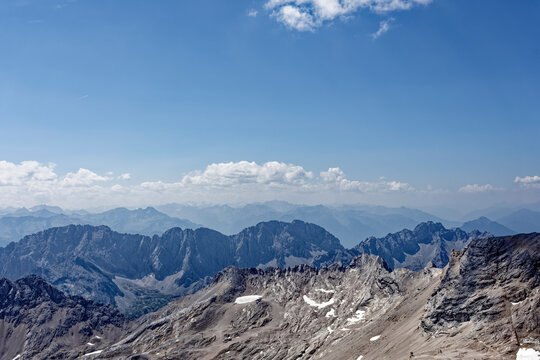 Layered Alpine Mountain Ranges and Paraglider Viewed from Zugspitze Summit
