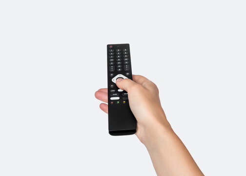 Hand Holding Remote Control Against Neutral Background