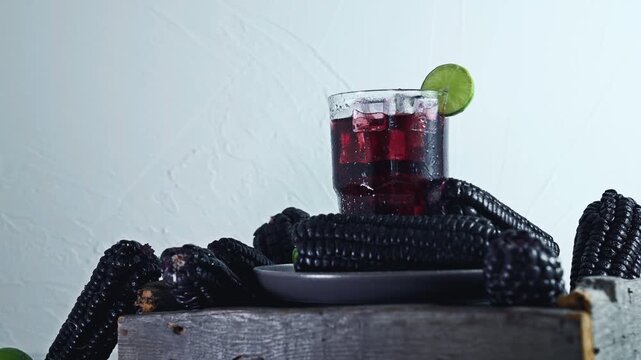 Pouring Peruvian Chicha Morada Purple Corn Drink with Lime and Cinnamon
