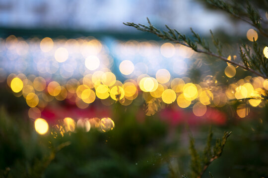 Christmas lights on roof of building are out of focus. Narrow banner. Bokeh. Concept of Christmas decorations on street. Christmas and New Year celebrations