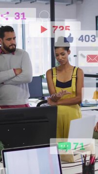 Animation of changing numbers, icons in notification bars, diverse coworkers sharing ideas in office