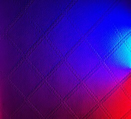 Naklejka premium Abstract quilted leather texture with vibrant blue and red neon gradient lighting effect