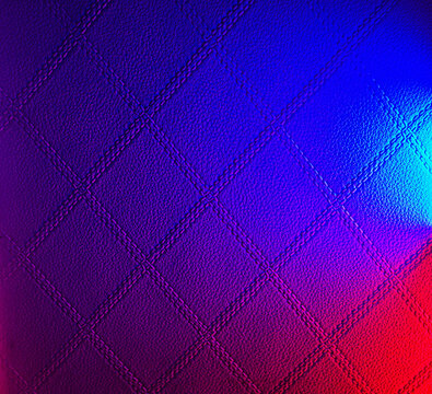 Abstract quilted leather texture with vibrant blue and red neon gradient lighting effect