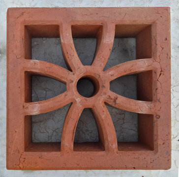 Decorative terracotta breeze block with a floral geometric pattern for architectural design