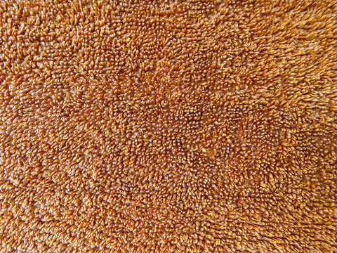 Brown towel fabric texture background, close up of soft terry cloth textile material.