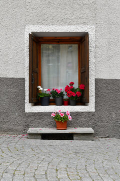 Traditional wooden window with flowers in Cogne, Aosta Valley, Italy