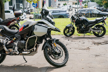 Fototapeta premium Dual sport adventure motorcycle parked on a paved city road with dual headlights and luggage racks for long distance travel
