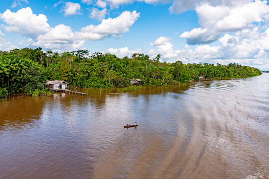 River dweller lifestyle: Local people in a canoe on the Amazon River, Belem, Para