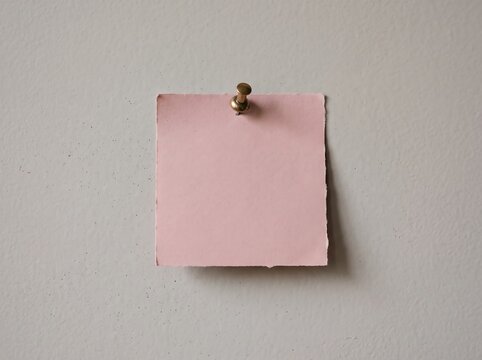 Pink sticky note pinned to a textured grey wall for office reminders and business messages