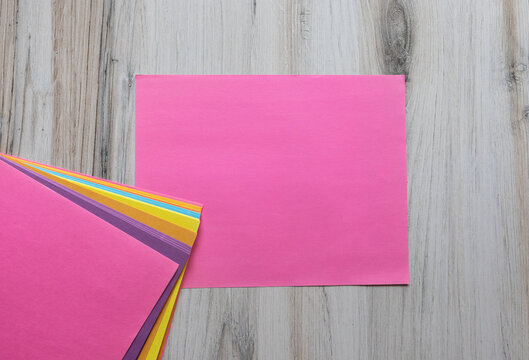 Blank pink note paper on wooden background