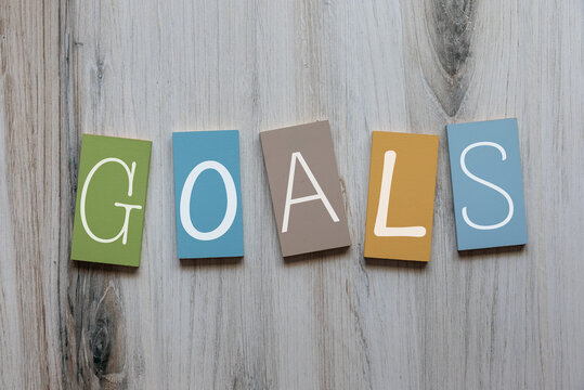 Flat lay photo of the word goals on wooden tiles background image