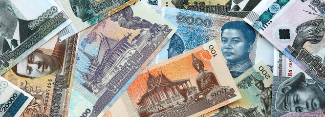 Cambodian riel money banknotes pile on table. Cambodia bills of KHR currency close up © Larysa