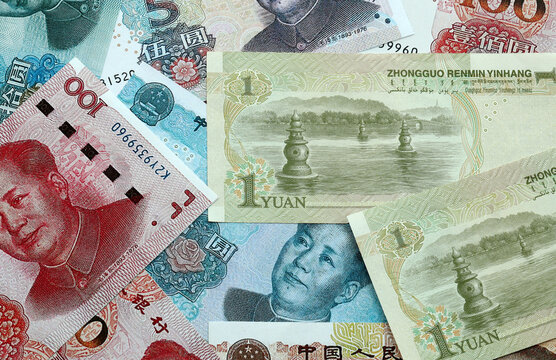 Chinese yuan money banknotes pile on table. China bills of CNY currency close up. Concept of economy