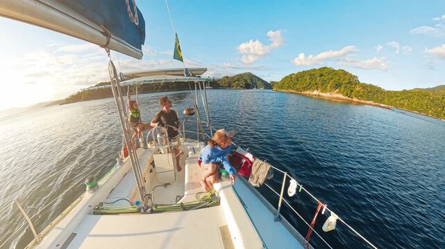 Family sailing on the small sailing boat in Brazil