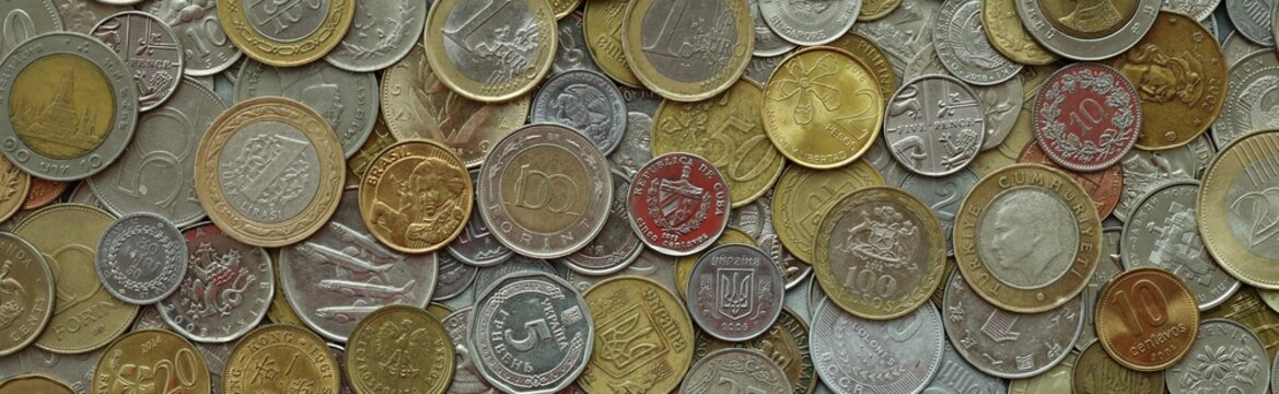 Large amount of different coins from various money currencies. Treasure and numismatics concept