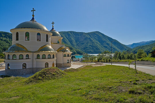 Orthodox church in Montenegro with mountain landscape and blue sky background
