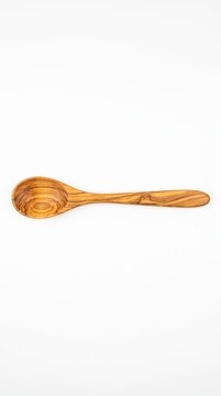 Handcrafted olive wood spoon centered on a white background. Represents mindful cooking and natural kitchen rituals. Perfect for food blogs, culinary branding, and slow living content.
