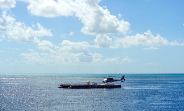 Helicopter landing on a pontoon near Airlie Beach Queensland