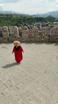 Woman in Red Dress at Rabati Castle