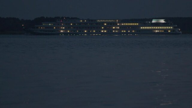 Cruising ship moves on the river at night