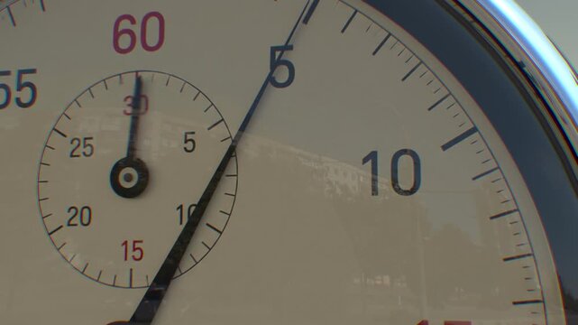 Close up of analogue stopwatch going from 0 to 10 seconds with slow camera push in