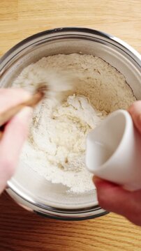 Water is added to flour in bowl for simple dough. Simple dough lesson teaches basic ratio, mixing and soft elastic texture. Use simple dough for flatbread, dumplings, noodles, crackers or wraps.