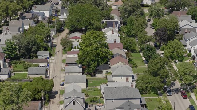 Medium income and middle class Midwestern American homes, houses, rental property residences, and townhouse duplexes in average older neighborhood outside Columbus, OH in Ohio suburb from drone aerial