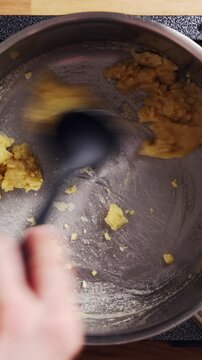 Culinary student fries flour in butter during sauce lesson. Teacher explains low heat, stirring and colour control in sauce lesson. Sauce lesson builds skills, timing, confidence and chef training.