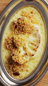 Spoon sprinkles almond and panko mix over baked cauliflower. Baked cauliflower has crunchy topping for vegetarian roast dinner. Serve baked cauliflower with potatoes, carrots, green beans or stuffing.