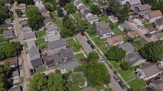 Medium income and middle class Midwestern American homes, houses, rental property residences, and townhouse duplexes in average older neighborhood outside Columbus, OH in Ohio suburb from drone aerial