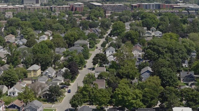 Medium income and middle class Midwestern American homes, houses, rental property residences, and townhouse duplexes in average older neighborhood outside Columbus, OH in Ohio suburb from drone aerial