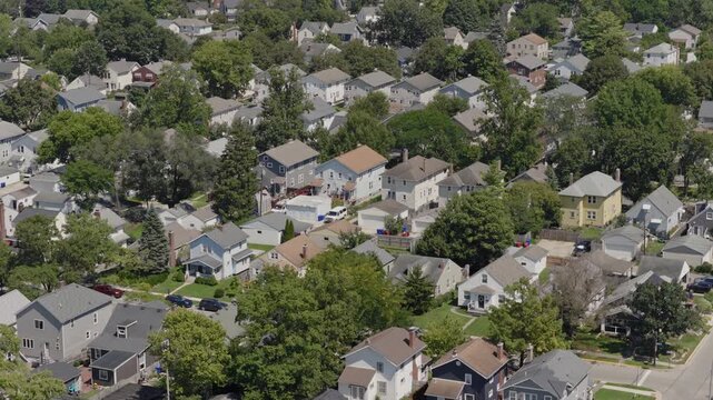 Medium income and middle class Midwestern American homes, houses, rental property residences, and townhouse duplexes in average older neighborhood outside Columbus, OH in Ohio suburb from drone aerial