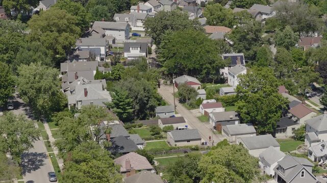 Medium income and middle class Midwestern American homes, houses, rental property residences, and townhouse duplexes in average older neighborhood outside Columbus, OH in Ohio suburb from drone aerial